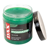 Green jar of DAX Bergamot Pomade with open lid on a white background