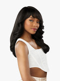 Woman with long, wavy black hair wearing a white top on a light gray background